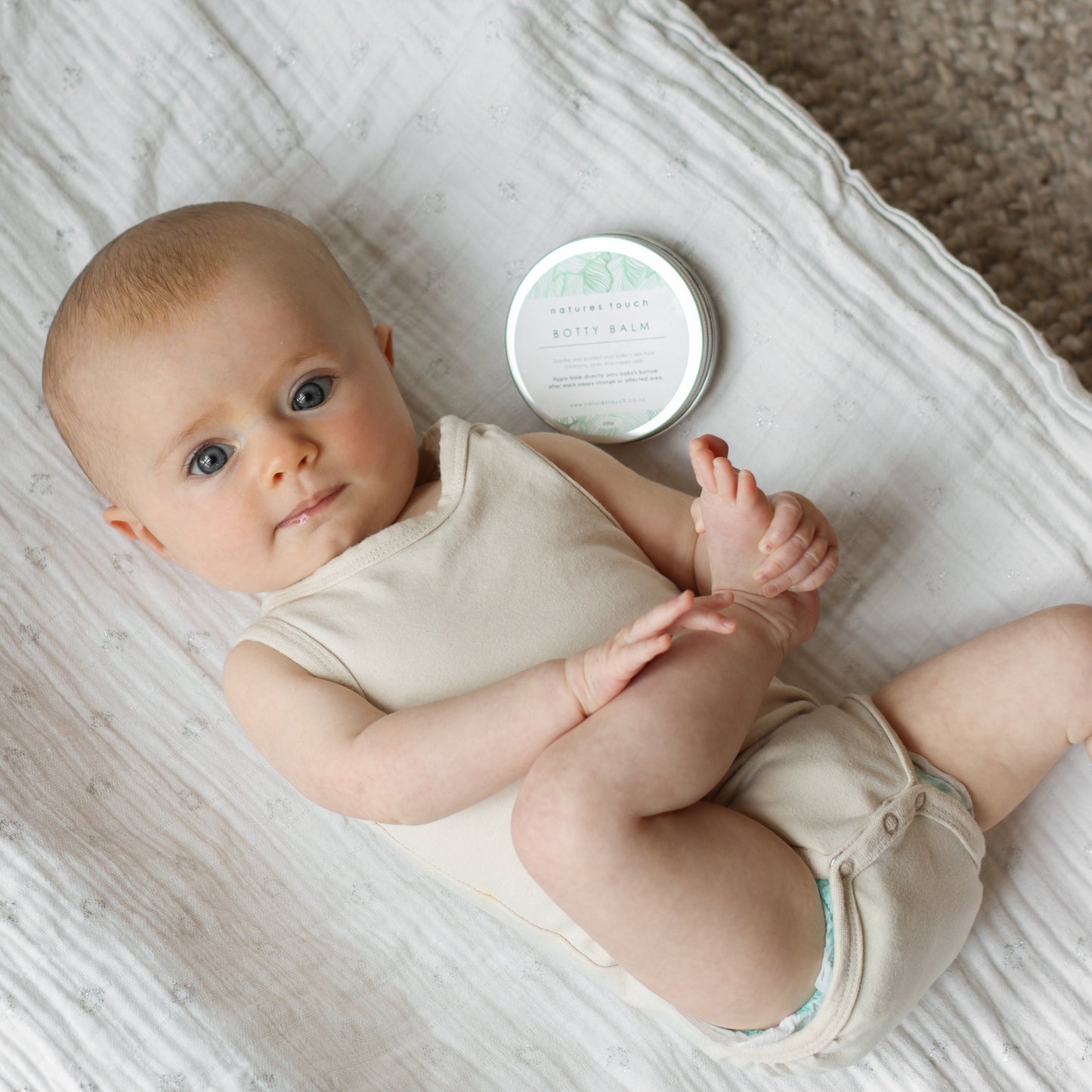 Healthy smiling baby after a nappy change